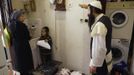 Rachel Kreus (L) speaks with her husband Yoel during the family's preparations for the Jewish Sabbath in Jerusalem's Mea Shearim neighbourhood June 29, 2012. The Kreus family are a member of Neturei Karta, a fringe ultra-Orthodox movement within the anti-Zionist bloc. The ultra-Orthodox Jews have gone from being a tiny minority in Israel's mostly secular society to its fastest-growing sector, now about 10 percent of the 7.8 million population. They are exempt from military duty in Israel but draft deferments and state subsidies for the ultra-Orthodox have become a divisive political issue in Israel, where the government must decide a new law by August to ensure more of them do military service. Picture taken June 29, 2012. REUTERS/Ronen Zvulun (JERUSALEM - Tags: RELIGION MILITARY POLITICS CIVIL UNREST) ATTENTION EDITORS - PICTURE 13 OF 21 FOR PACKAGE "ISRAEL'S ULTRA-ORTHODOX". SEARCH "ULTRA-ORTHODOX" FOR ALL PICTURES Published: Čec. 6, 2012, 10:03 dop.