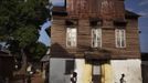 People walk past traditional colonial-era Board House on main road through Murray Town of Sierra Leone's capital Fre