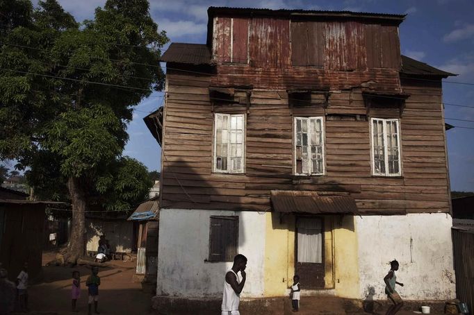 People walk past traditional colonial-era Board House on main road through Murray Town of Sierra Leone's capital Fre