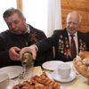 Vasily Knyazev, World War Two veteran, fills a glass with vodka at the &quot;Stalin Line&quot; memorial near the village of Goroshki