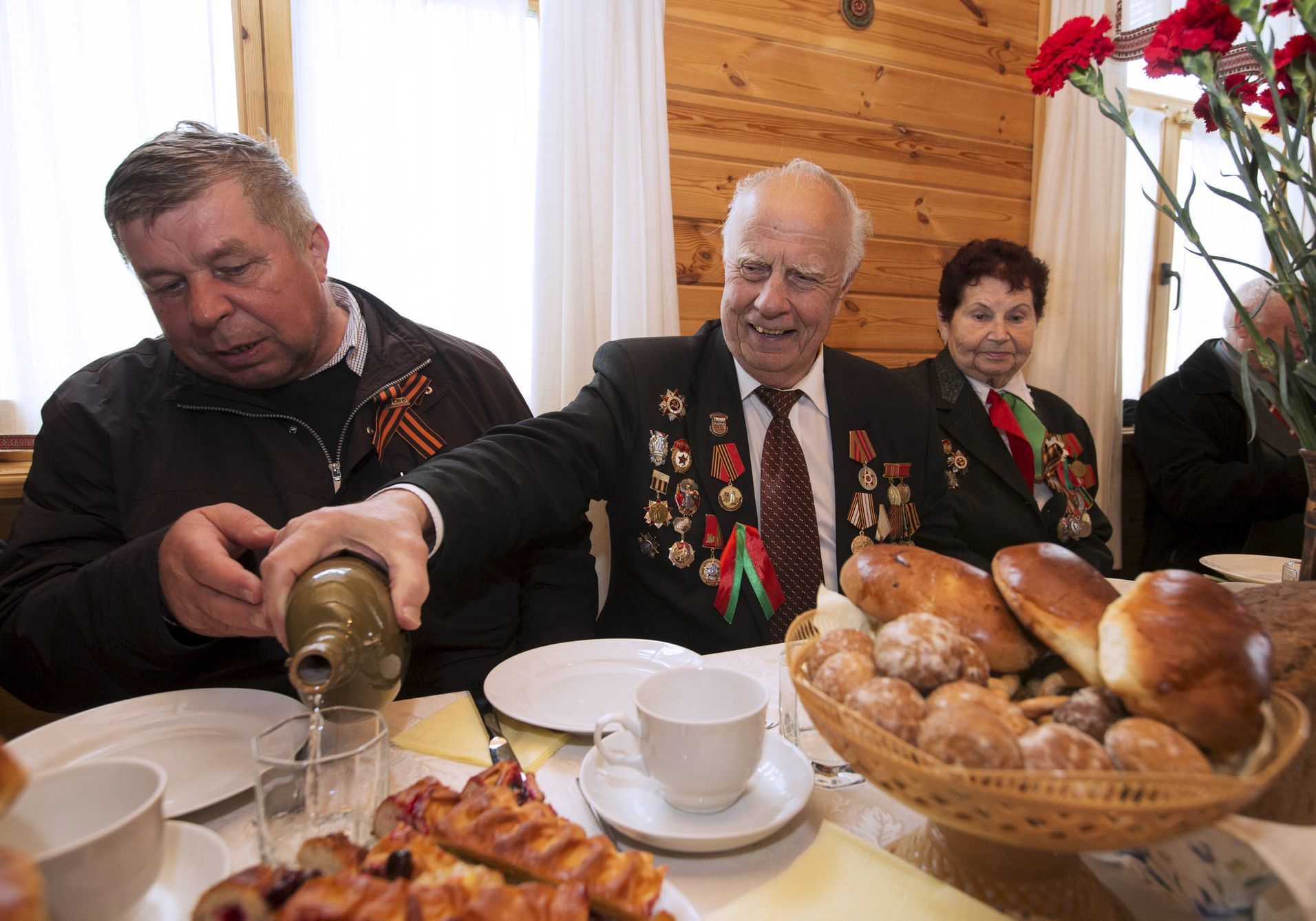 Vasily Knyazev, World War Two veteran, fills a glass with vodka at the &quot;Stalin Line&quot; memorial near the village of Goroshki