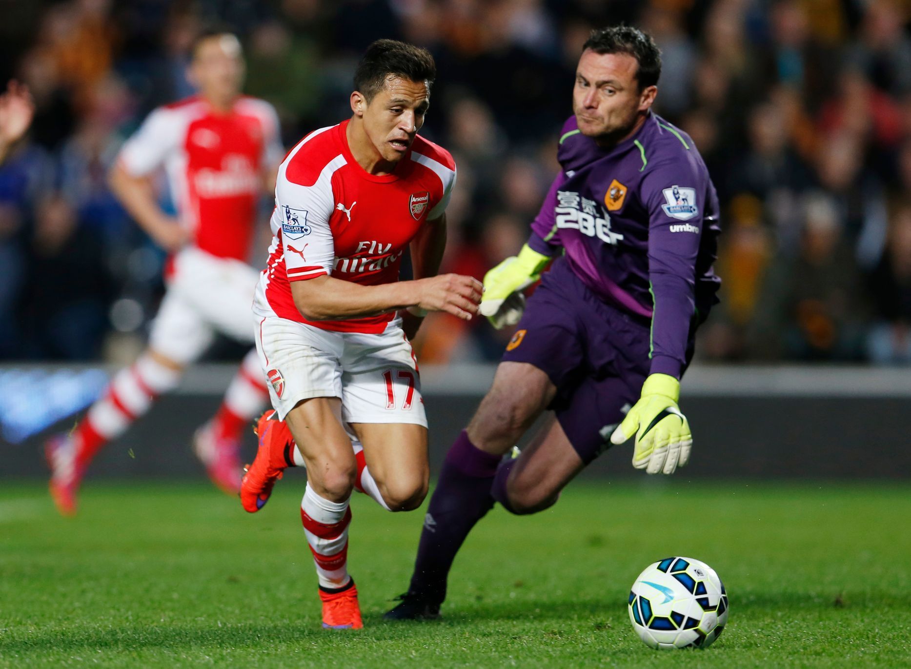Football: Alexis Sanchez scores the third goal for Arsenal as Hull's Steve Harper looks on