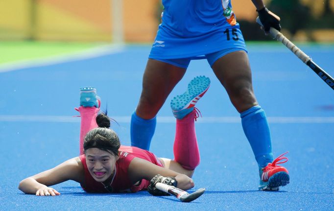 Women's Pool B Japan v India - Olympic Hockey Centre - Rio de Janeiro, Brazil - 07/08/2016. Emi Nishikori (JPN) of Japan (L) competes with Poonam Rani (IND) of India