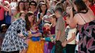 Catherine, Duchess of Cambridge, receives a flower from a girl as she meets locals during her visit to the Blue Mountains suburb of Winmalee