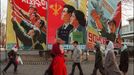 Pedestrians walk past giant propaganda boards 27 January1995 in central Pyongyang.