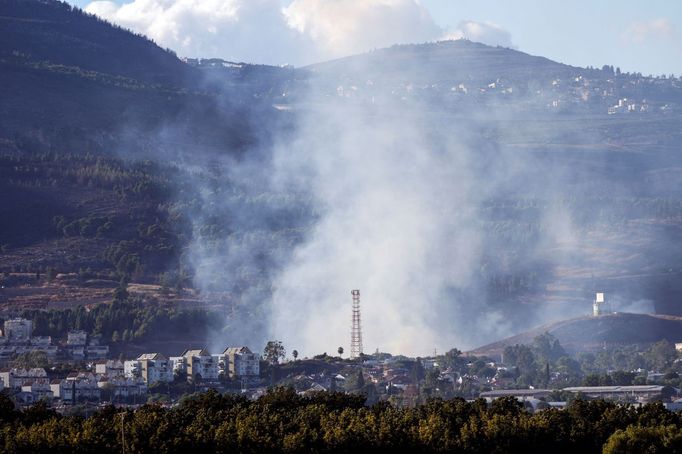 Kouř stoupající nad izraelským městem Kirjat Šmona po odpalu raket z Libanonu na Izrael