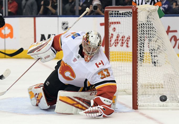 Jan 16, 2020; Toronto, Ontario, CAN;   Calgary Flames goalie David Rittich (33) makes a save against Toronto Maple Leafs in the third period at Scotiabank Arena. Mandator