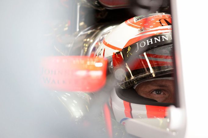 McLaren Formula One driver Jenson Button of Britain sits in his car in the team garage during the third practice session of the Australian F1 Grand Prix at the Albert Par