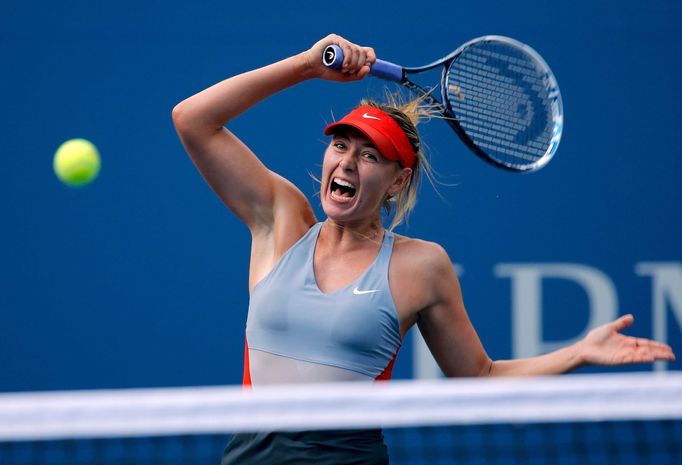 Maria Sharapova of Russia hits a return to Caroline Wozniacki of Denmark during their match at the 2014 U.S. Open tennis tournament in New York