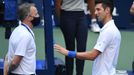 Sep 6, 2020; Flushing Meadows, New York, USA; Novak Djokovic of Serbia discusses with a tournament official after being defaulted for striking a lines person with a ball