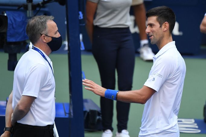 Sep 6, 2020; Flushing Meadows, New York, USA; Novak Djokovic of Serbia discusses with a tournament official after being defaulted for striking a lines person with a ball