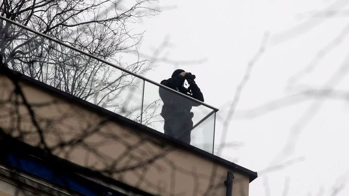Příslušník speciálního policejního komanda obhlíží ze střechy situaci u hotelu Bayerischer Hof. Mnichovská konference nemá bezpečnost jen v názvu, ale i všude kolem