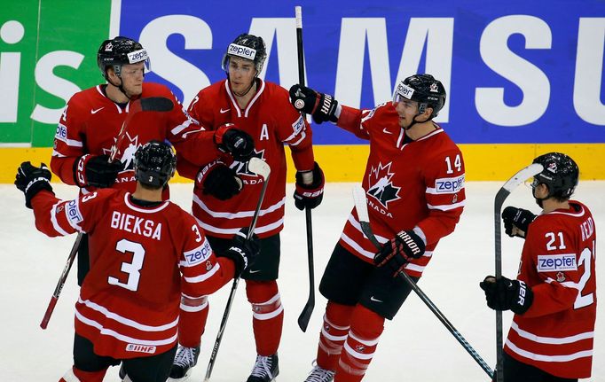 Canada's Morgan Rielly (top, L) celebrates his goal against the Czech Republic with team mates during the second period of their men's ice hockey World Championship group