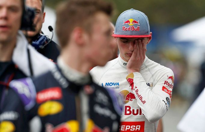 Toro Rosso Formula One driver Max Verstappen of the Netherlands (R) reacts after the qualifying session of the Australian F1 Grand Prix at the Albert Park circuit in Melb