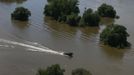 A boat of the German armed forces Bundeswehr rides in the flooded pastures after floods near Magdeburg in the federal state of Saxony Anhalt, June 10, 2013. Tens of thousands of Germans, Hungarians and Czechs were evacuated from their homes on Wednesday as soldiers raced to pile up sandbags to hold back rising waters in the region's worst floods in a decade. REUTERS/Thomas Peter (GERMANY - Tags: DISASTER ENVIRONMENT)