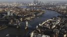 ATTENTION EDITORS - EMBARGOED FOR PUBLICATION TO 00:01 GMT JANUARY 11, 2013 Tower Bridge and the Canary Wharf financial district (at rear) are seen at dusk in an aerial photograph from The View gallery at the Shard, western Europe's tallest building, in London January 8, 2013. The View, the public viewing deck accessible by high speed elevators on the 309 metre (1013 feet) Shard building, opens on February 1. Picture taken January 8, 2013. REUTERS/Andrew Winning (BRITAIN - Tags: TRAVEL CITYSCAPE) TEMPLATE OUT Published: Led. 10, 2013, 12:07 odp.