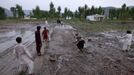 RNPS IMAGES OF THE YEAR 2012 - Children play cricket in the rain on the demolished site of the compound of Osama bin Laden, in Abbottabad April 20, 2012. Osama bin Laden was killed on May 2, 2011, by a United States special operations military unit in a raid on his compound in Abbottabad. REUTERS/Akhtar Soomro (PAKISTAN - Tags: SOCIETY POLITICS) Published: Pro. 4, 2012, 1:15 dop.