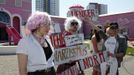 Demonstrators protest with a performance against a "Barbie Dreamhouse" of Mattel's Barbie dolls in Berlin, May 16, 2013. The life-sized house, covering about 1,400 square metres offers visitors to try on Barbie's clothes in her walk-in closet, tour her living room and her kitchen. REUTERS/Fabrizio Bensch (GERMANY - Tags: ENTERTAINMENT SOCIETY CIVIL UNREST) Published: Kvě. 16, 2013, 12:23 odp.