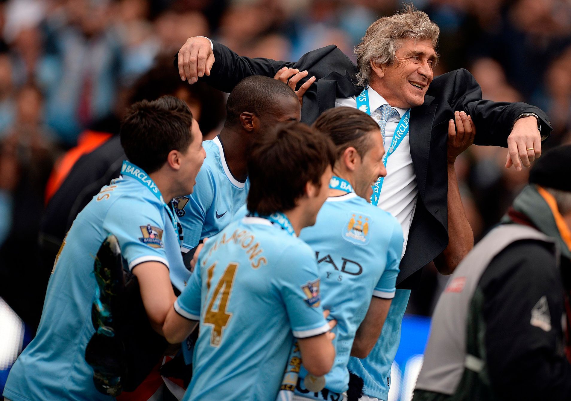 Manchester City's manager Pellegrini is carried by players as they celebrate winning the league after their English Premier League soccer match against West Ham United at the Etihad Stadium in Manches