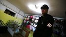 Ariunbold, a leader of the Mongolian neo-Nazi group Tsagaan Khass, walks through a lingerie store as he leaves the group's headquarters in Ulan Bator June 22, 2013. The group has rebranded itself as an environmentalist organisation fighting pollution by foreign-owned mines, seeking legitimacy as it sends Swastika-wearing members to check mining permits. Over the past years, ultra-nationalist groups have expanded in the country and among those garnering attention is Tsagaan Khass, which has recently shifted its focus from activities such as attacks on women it accuses of consorting with foreign men to environmental issues, with the stated goal of protecting Mongolia from foreign mining interests. This ultra-nationalist group was founded in the 1990s and currently has 100-plus members. Picture taken June 22, 2013. REUTERS/Carlos Barria (MONGOLIA - Tags: POLITICS ENVIRONMENT BUSINESS SOCIETY EMPLOYMENT) ATTENTION EDITORS: PICTURE 15 OF 25 FOR PACKAGE 'MONGOLIA'S ENVIRONMENTAL NEO-NAZIS'. TO FIND ALL IMAGES SEARCH 'TSAGAAN KHASS' Published: Čec. 2, 2013, 9:58 dop.