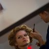 Model is reflected in a mirror as she has her makeup applied before the Diane von Furstenberg Spring/Summer 2015 collection show during New York Fashion Week in the Manhattan borough of New York