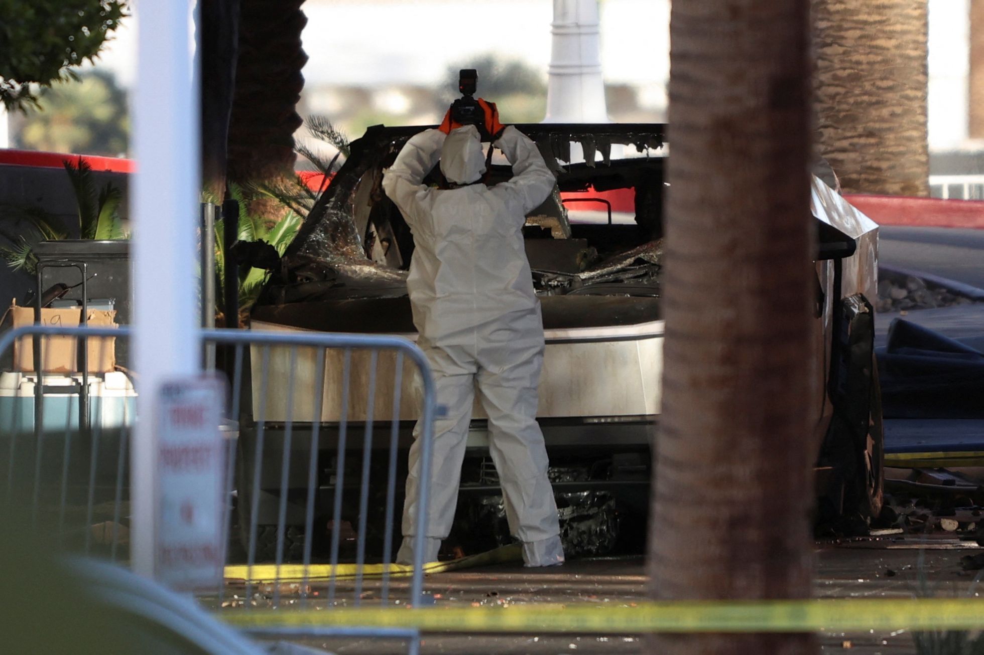 Firefighters work at the Tesla Cybertruck which burned at the entrance of Trump Tower in Las Vegas