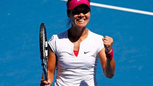 Li Na of China celebrates defeating Lucie Safarova of the Czech Republic during t