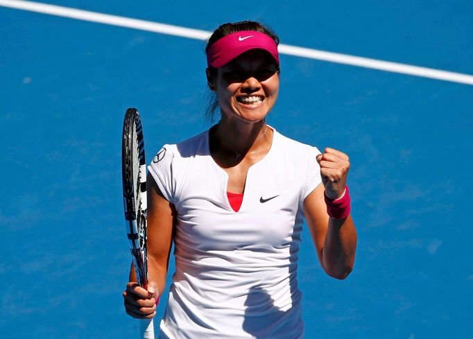 Li Na of China celebrates defeating Lucie Safarova of the Czech Republic during t