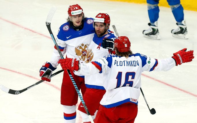 Russia's Danis Zaripov (C) celebrates his goal against Kazakhstan with team mates Sergei Plotinikov (R) and Viktor Tikhonov during the second period of their men's ice ho