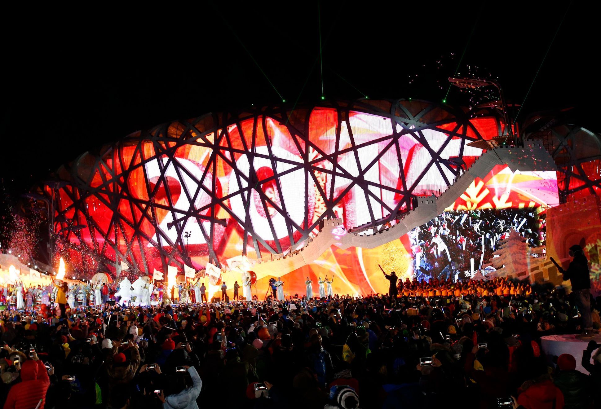 Performers and attendees celebrate the arrival of the new year in front of the National Stadium in Beijing