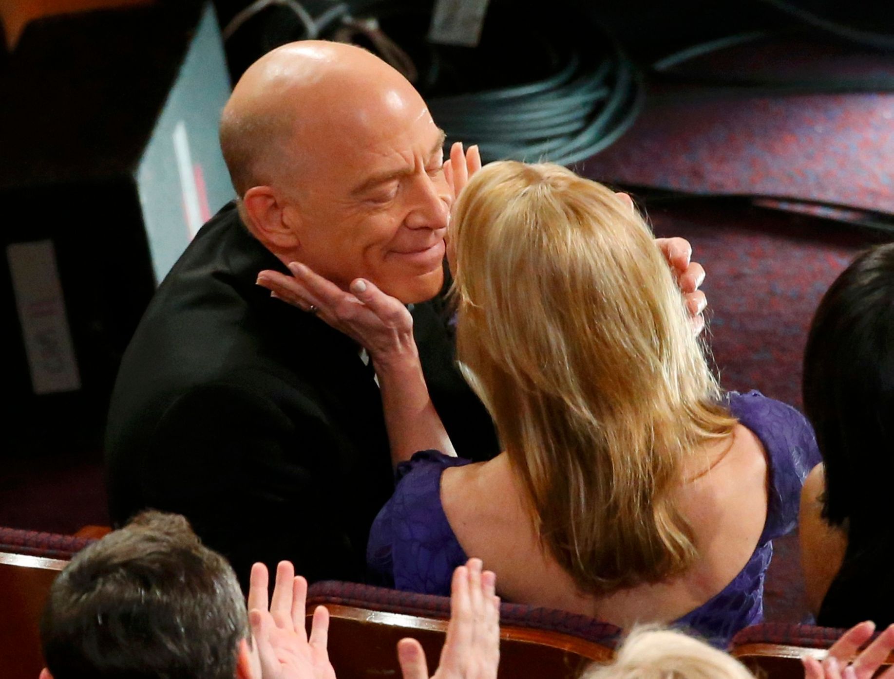 Best supporting actor winner Simmons  is congratulated by his wife Michelle Schumache at the 87th Academy Awards in Hollywood