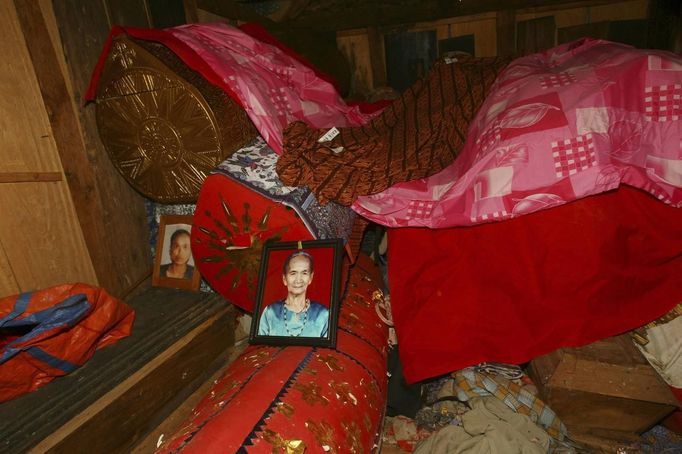 Coffins containing mummies are seen in a grave house called Patane during a ritual in the Toraja district of Indonesia's South Sulawesi Province, August 23, 2012. The ritual, called Ma'nene, involves changing the clothes every three years of mummified ancestors to honor love for the deceased. Locals believe dead family members are still with them, even if they died hundreds of years ago, a family spokesman said. Picture taken August 23, 2012. REUTERS/Yusuf Ahmad (INDONESIA - Tags: SOCIETY RELIGION) Published: Srp. 24, 2012, 1:10 odp.