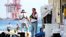 Salvage master Nick Sloane (R) talks on his mobile phone before boarding Costa Concordia cruise liner during the refloat operation at Giglio harbour at Giglio Island July