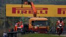 The car of Marussia Formula One driver Max Chilton of Britain is removed from the tracks during the second practice session of the Malaysian F1 Grand Prix at Sepang Inter