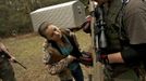 A member of the North Florida Survival Group shows the daughter of another member how to operate the magazine release of an SKS rifle during a field training exercise in Old Town, Florida, December 8, 2012. The group trains children and adults alike to handle weapons and survive in the wild. The group passionately supports the right of U.S. citizens to bear arms and its website states that it aims to teach "patriots to survive in order to protect and defend our Constitution against all enemy threats". Picture taken December 8, 2013. REUTERS/Brian Blanco (UNITED STATES - Tags: SOCIETY POLITICS) ATTENTION EDITORS: PICTURE 16 OF 20 FOR PACKAGE 'TRAINING CHILD SURVIVALISTS' SEARCH 'FLORIDA SURVIVAL' FOR ALL IMAGES Published: Úno. 22, 2013, 1:01 odp.