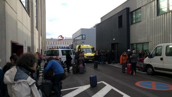 People are seen at the scene of explosions at Zaventem airport near Brussels, Belgium