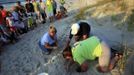 Turtle volunteers Marianne Glaze (L), Don Pease (C) and Amanda Jenkins take an inventory of a hatched sea turtle nest at Myrtle Beach State Park in Myrtle Beach, South Carolina August 4, 2012. The empty egg shells are categorized and the information is sent to researchers. Turtle volunteers walk the area's beaches along South Carolina's coast daily during the nesting season, looking for signs of turtle activity and keeping tabs on the progress of the endangered species of turtles that lay their eggs along the coast. Picture taken August 4, 2012. REUTERS/Randall Hill (UNITED STATES - Tags: ANIMALS ENVIRONMENT)