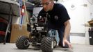 Matt Cross, an engineer with Crew 125 EuroMoonMars B mission, works on a rover at the Mars Desert Research Station (MDRS) outside Hanksville in the Utah desert March 3, 2013. The MDRS aims to investigate the possibility of a human exploration of Mars and uses the Utah desert's Mars-like terrain to simulate working conditions on the red planet. Scientists, students and enthusiasts work together developing field tactics and studying the terrain. All outdoor exploration is done wearing simulated spacesuits and carrying air supply packs and crews live together in a small communication base with limited amounts of electricity, food, oxygen and water. Everything needed to survive must be produced, fixed and replaced on site. Picture taken March 3, 2013. REUTERS/Jim Urquhart (UNITED STATES - Tags: SCIENCE TECHNOLOGY SOCIETY ENVIRONMENT) ATTENTION EDITORS: PICTURE 6 OF 31 FOR PACKAGE 'MARS IN THE DESERT' SEARCH 'JIM MARS' FOR ALL IMAGES Published: Bře. 11, 2013, 2:03 odp.