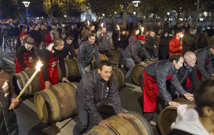 Men roll barrels of Beaujolais Nouveau wine for the official launch of the 2012 vintage in the center of Lyon early November 15, 2012. REUTERS/Robert Pratta (FRANCE - Tags: SOCIETY) Published: Lis. 15, 2012, 2:15 dop.