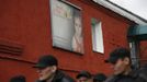 Inmates walk past a poster that reads: 'Help Children' at a high-security male prison camp outside Russia's Siberian city of Krasnoyarsk May 14, 2013. High-security male prison camp number 17 is intended to house male inmates who are serving a sentence for the first time, and have been convicted for serious crimes. Prisoners at the facility work in wood and metal processing shops, manufacture furniture, sew clothes and do other kinds of work. They can also take part in educational, sport and cultural programs. Picture taken May 14, 2013. REUTERS/Ilya Naymushin (RUSSIA - Tags: CRIME LAW SOCIETY) ATTENTION EDITORS: PICTURE 6 OF 29 FOR PACKAGE 'INSIDE SIBERIA'S PRISONS' SEARCH 'ILYA PRISON' FOR ALL IMAGES Published: Čer. 19, 2013, 10:02 dop.