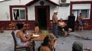 Members of the Gabarri-Echevarria family gather outside the family home at the Spanish gypsy settlement of Puerta de Hierro, in the outskirts of Madrid June 26, 2012. Fifty-four families have been living in Puerta de Hierro, on the banks of the Manzanares river for over 50 years. Since the summer of 2010, the community has been subject to evictions on the grounds that the dwellings are illegal. Families whose houses have been demolished, move in with relatives whose houses still remain while the debris keeps piling up around them as more demolitions take place. Picture taken June 26, 2012. REUTERS/Susana Vera (SPAIN - Tags: SOCIETY) ATTENTION EDITORS - PICTURE 22 OF 31 FOR PACKAGE 'GYPSY SITE DEMOLISHED' SEARCH 'GYPSY SITE' FOR ALL IMAGES Published: Lis. 5, 2012, 4:12 odp.