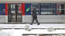 A man walks past a commuter train on a snow-covered platform at the Gare Saint Lazare train station in Paris March 12, 2013 as winter weather with snow and freezing temperatures returns to northern France. REUTERS/Gonzalo Fuentes (FRANCE - Tags: ENVIRONMENT TRANSPORT) Published: Bře. 12, 2013, 2:28 odp.