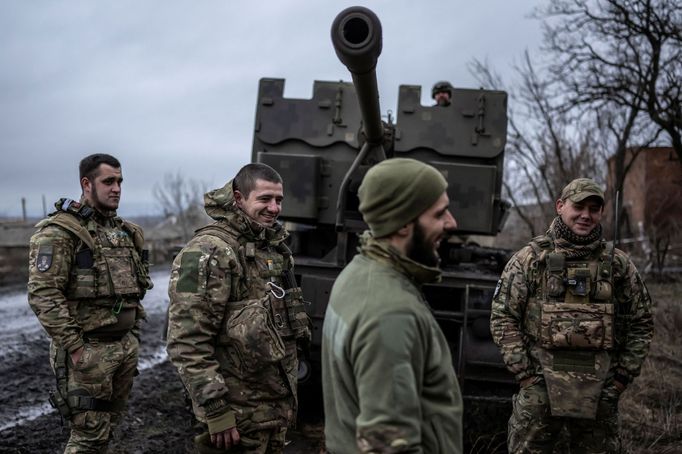 Service members of Ukrainian Joint Assault Brigade Fury stand next to an S60 cannon near the front line town of Bakhmut, amid Russia's attack on Ukraine, in Donetsk regio