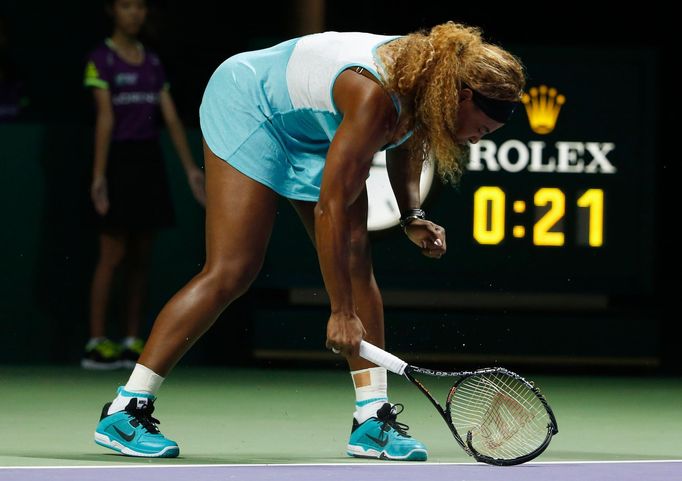 Serena Williams of the U.S. smashes her second racquet during her WTA Finals singles semi-finals tennis match against Caroline Wozniacki of Denmark, at the Singapore Indo