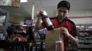 Abel Santiago, 21, serves a customer at a 7-Eleven convenience store in Santa Monica, California April 24, 2012. Santiago studied for one year at Universidad Anahuac Oaxaca for a degree in law. He has worked at the store for five months and hopes to return to Mexico to finish his degree.