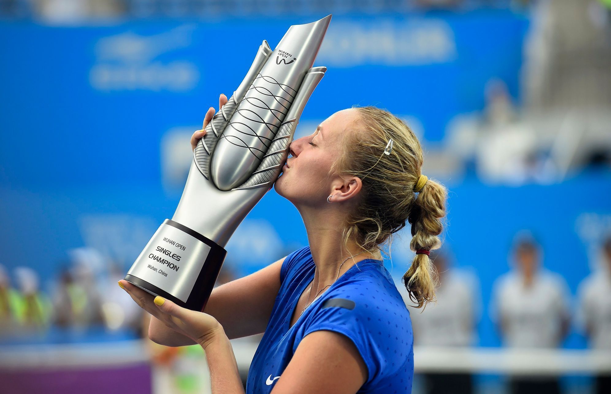 Kvitova of the Czech Republic kisses the trophy after winning the women's singles final match against Bouchard of Canada at the Wuhan Open Tennis Tournament, in Wuhan