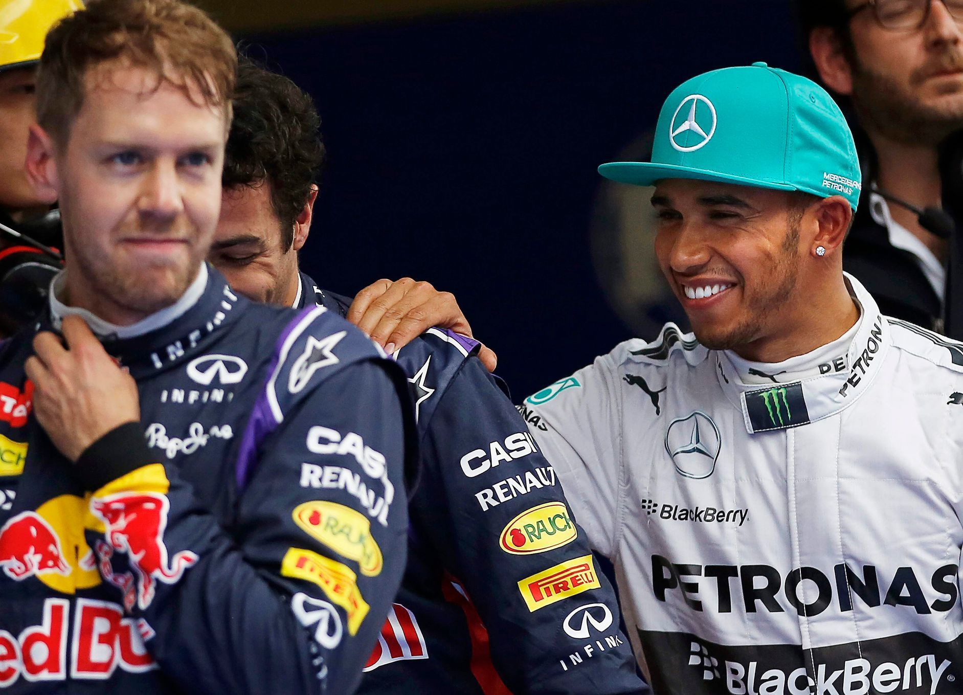 Mercedes Formula One driver Hamilton celebrates with second-fastest Red Bull Formula One driver Ricciardo and third-fastest Vettel of Germany, after taking pole position at qualifying session of Chine