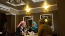 Chechen women chat in a cafe in the centre of the Chechen capital Grozny April 23, 2013. The naming of two Chechens, Dzhokhar and Tamerlan Tsarnaev, as suspects in the Boston Marathon bombings has put Chechnya - the former site of a bloody separatist insurgency - back on the world's front pages. Chechnya appears almost miraculously reborn. The streets have been rebuilt. Walls riddled with bullet holes are long gone. New high rise buildings soar into the sky. Spotless playgrounds are packed with children. A giant marble mosque glimmers in the night. Yet, scratch the surface and the miracle is less impressive than it seems. Behind closed doors, people speak of a warped and oppressive place, run by a Kremlin-imposed leader through fear. Picture taken April 23, 2013. REUTERS/Maxim Shemetov (Russia - Tags: SOCIETY POLITICS FOOD) ATTENTION EDITORS: PICTURE 26 OF 40 FOR PACKAGE 'INSIDE MODERN CHECHNYA'. SEARCH 'REBUILDING CHECHNYA' FOR ALL IMAGES Published: Kvě. 1, 2013, 8:08 dop.