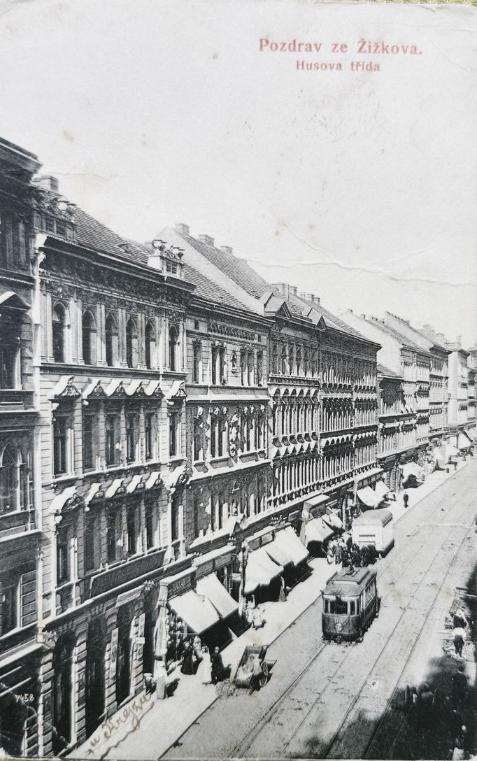 Husitská ulice ožívala vždy v poledne, kdy se přes její spodní část vraceli dělníci z karlínských továren domů na Žižkov, 1909.