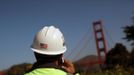 A worker talks on a cell phone near the new Bridge Pavilion on the south end of the Golden Gate Bridge as the iconic landmark is prepared for its 75th anniversary in late May, in San Francisco, California May 7, 2012. Enhancements such as a Bridge Pavilion serving as a visitor intrepretation center, art deco Round House for a virtual photo experience, and additional bicycle and walking trails have been added ahead of the May 27 anniversary. REUTERS/Robert Galbraith (UNITED STATES - Tags: ANNIVERSARY SOCIETY) Published: Kvě. 7, 2012, 6:50 odp.